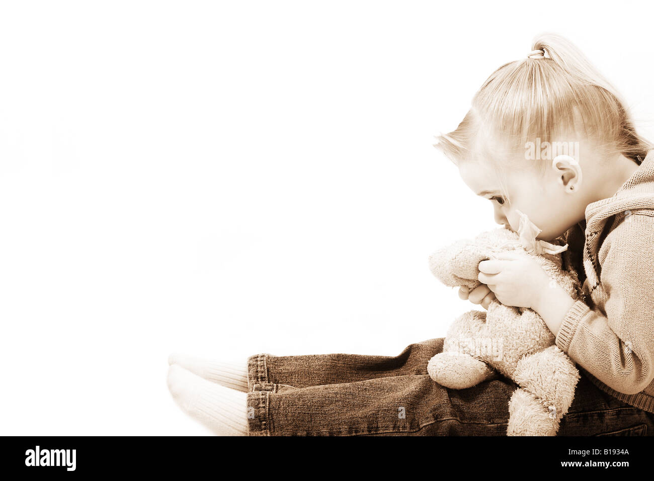 Girl holding her teddy bear Stock Photo