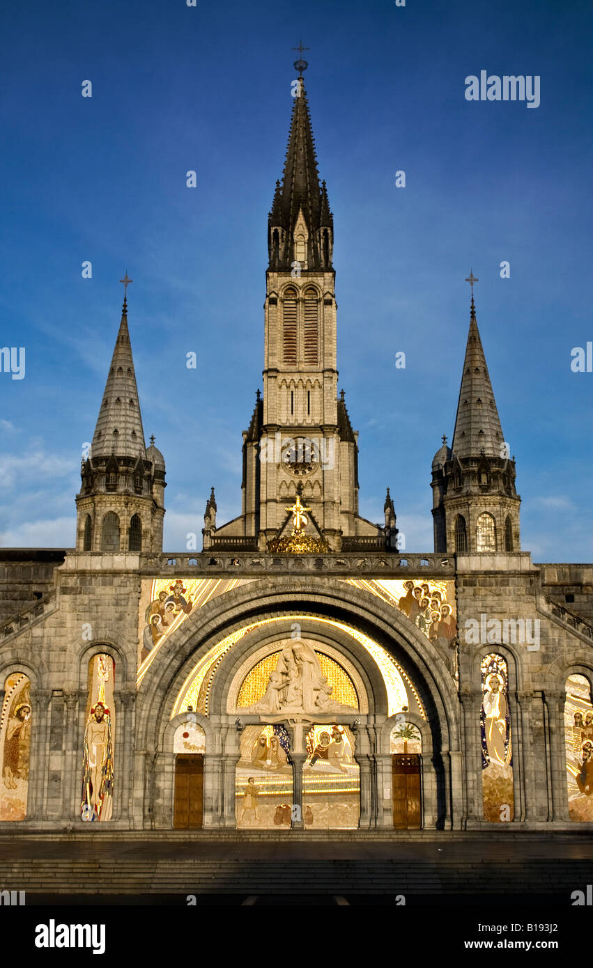 FRANCE, LOURDES. Morning sun rays falling on the church in the sanctuary in Lourdes France Stock Photo