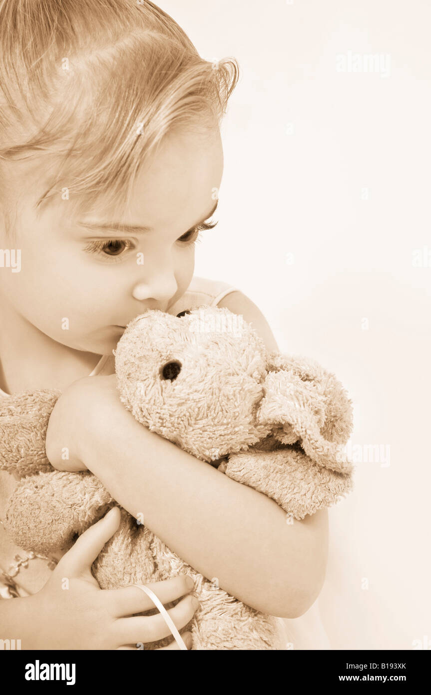 Girl kissing her stuffed animal Stock Photo Alamy