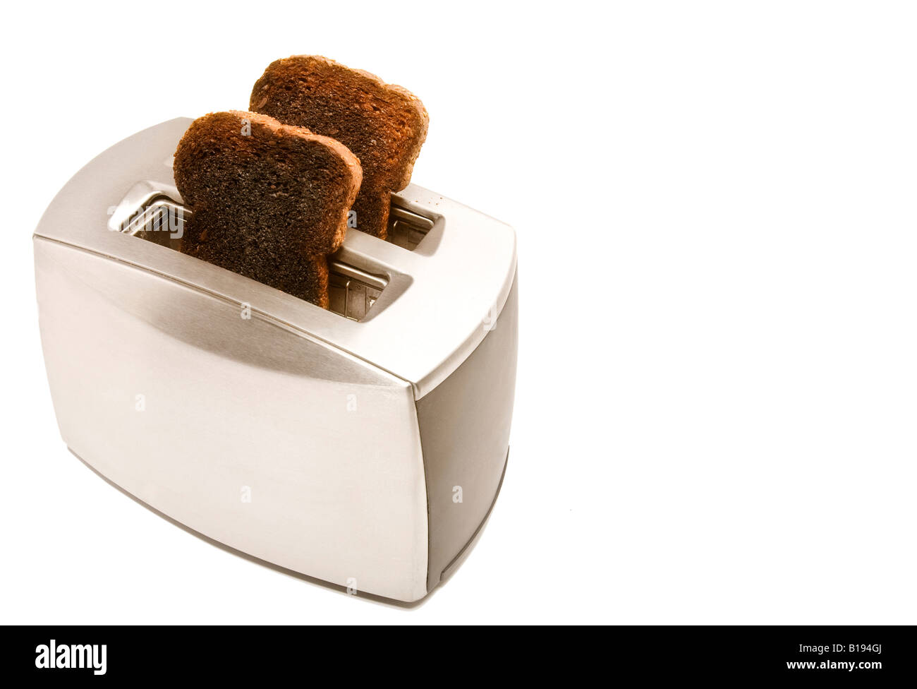 Burnt toast popping out of a toaster Stock Photo