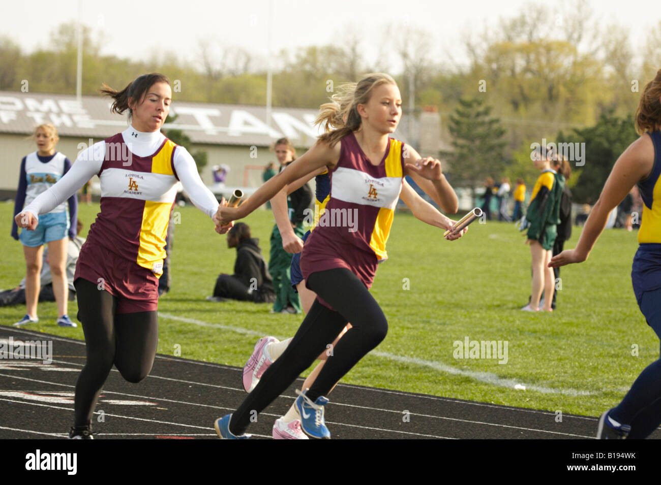 TRACK Glenview Illinois Baton handoff for female relay team high school girls track meet Stock Photo