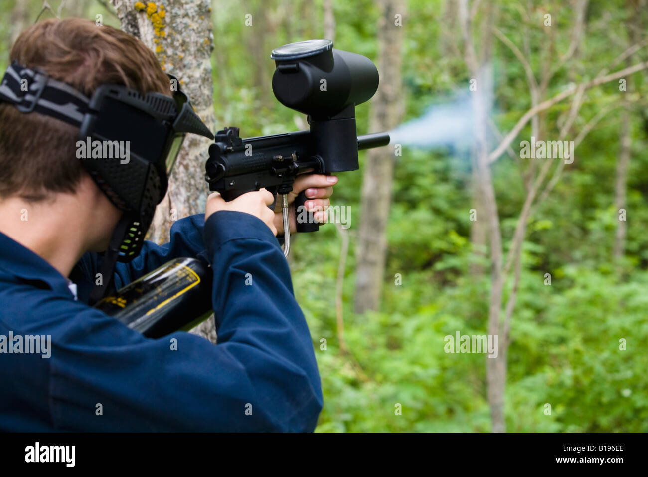Man shooting paintball gun Stock Photo Alamy