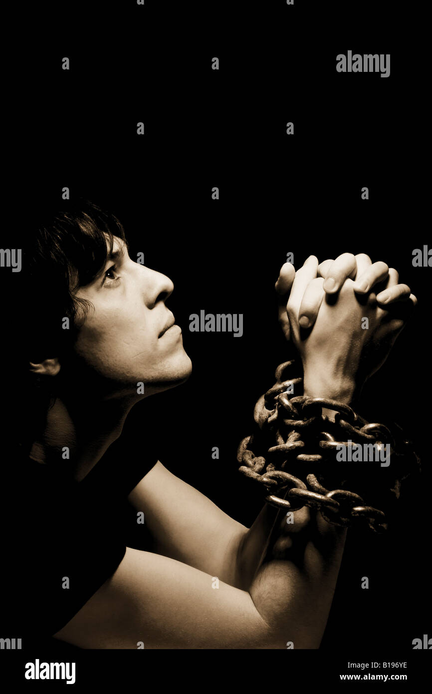 Hands praying chained hi-res stock photography and images - Alamy
