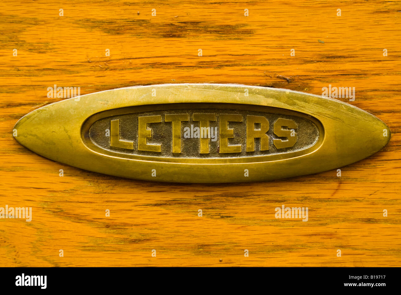 Brass letter slot inset in a wood door Stock Photo - Alamy