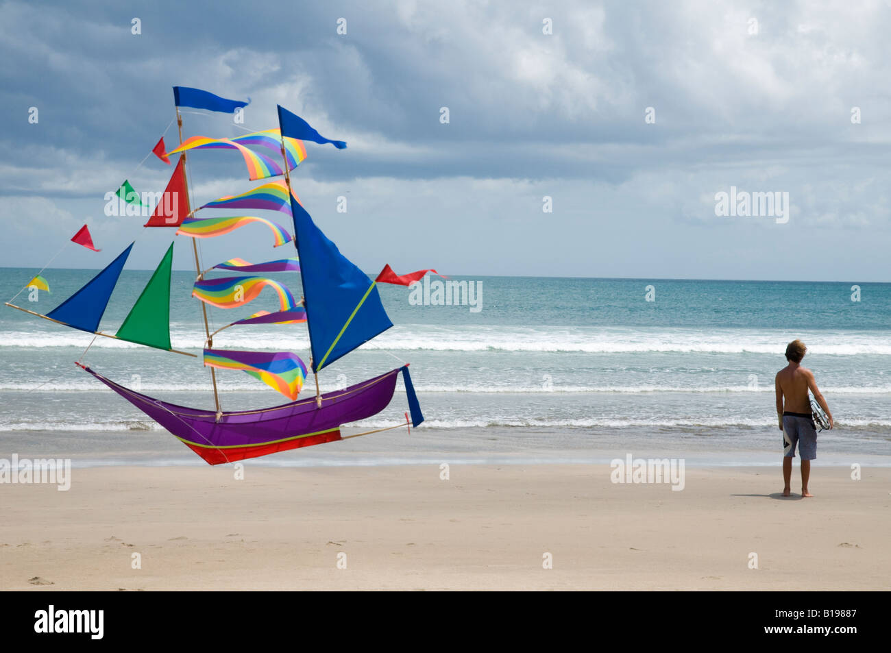 Indonesia Bali Island Kuta beach Surfing surfer holding his board