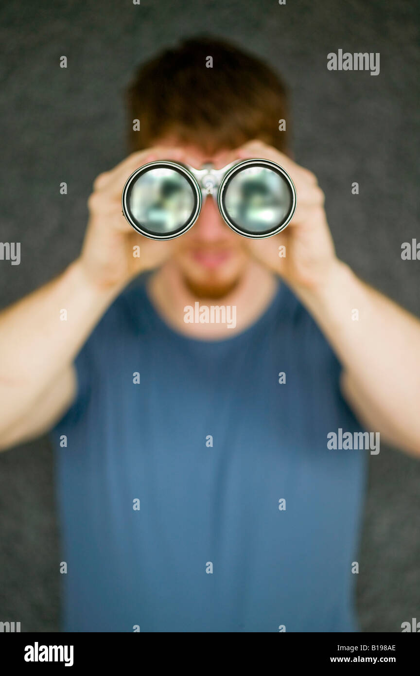 thirty-two year old man with long binoculars, Montreal, Quebec, Canada Stock Photo