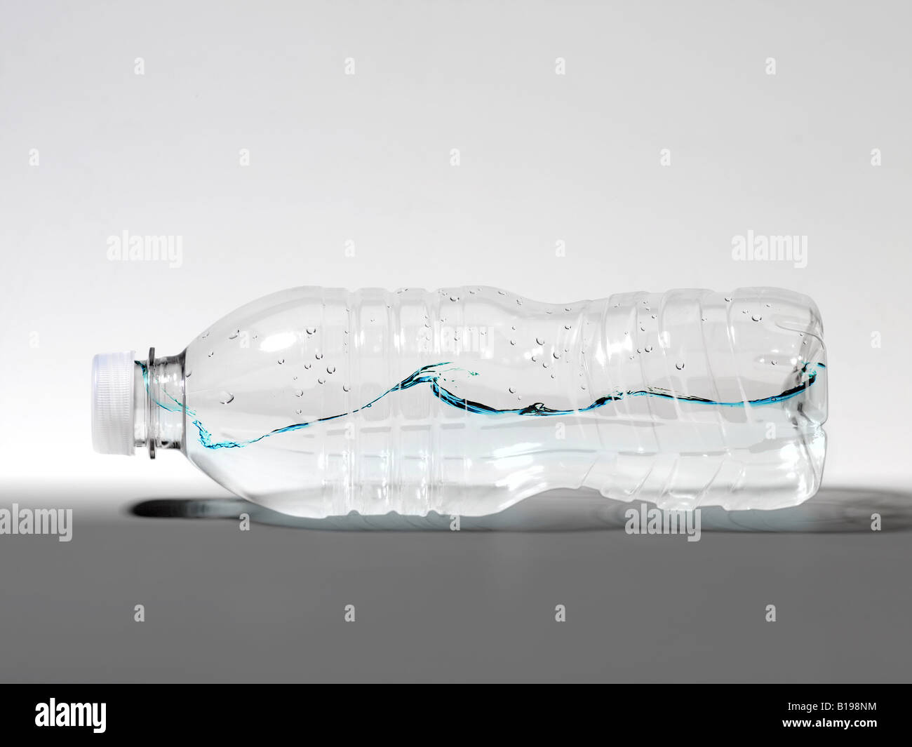 waves of water captured with a plastic water bottle. Stock Photo