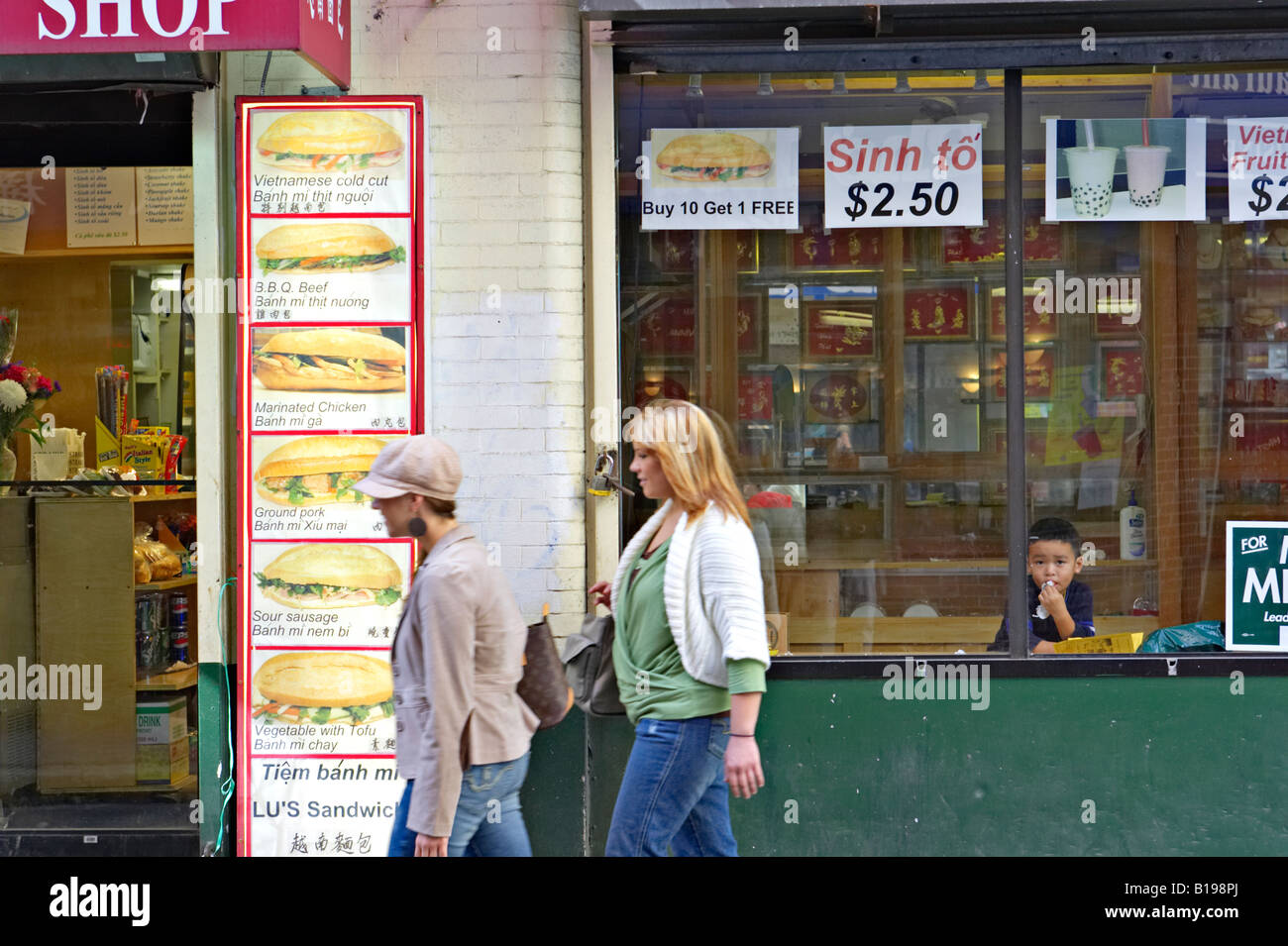 MASSACHUSETTS Boston People on sidewalk walk past restaurants and