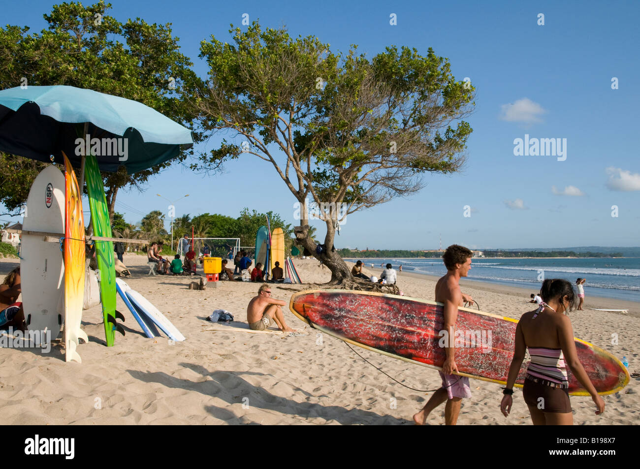 Indonesia Bali Island Kuta beach Surfing surfer with his board walking to the sea Stock Photo