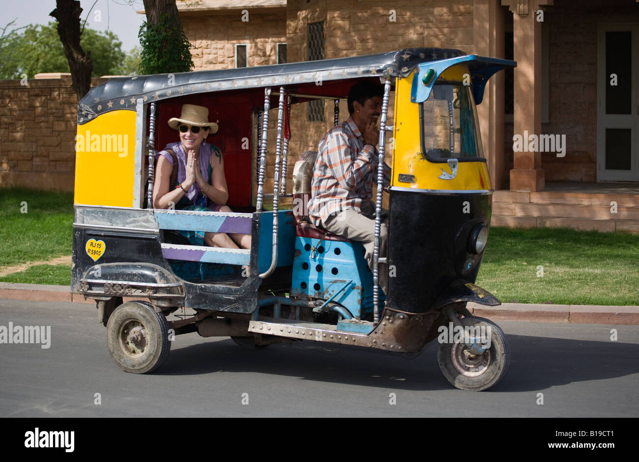 Christine Kolisch gets a ride in a tuk tuk or three wheeled motorcylce taxi in JODHPUR RAJASTHAN INDIA MR Stock Photo