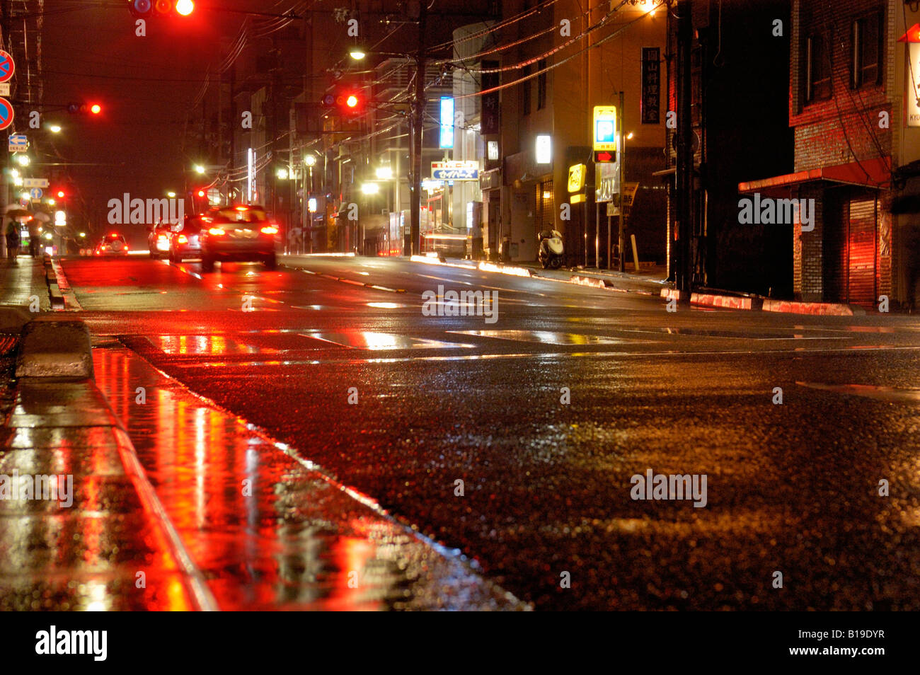 reflections in street at night Kyoto Japan Stock Photo