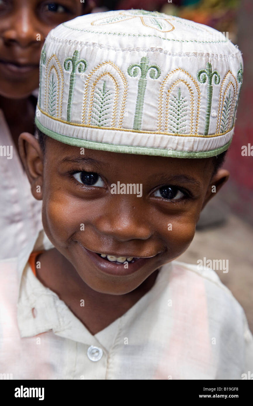 Kenya, Lamu Island, Lamu. A young Muslim boy of Lamu town wearing a kofia or traditional Lamu embroidered hat. Stock Photo