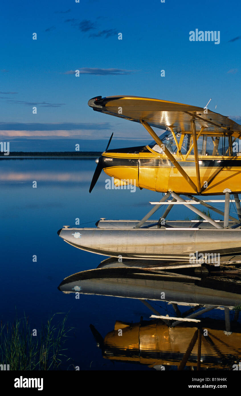 USA, Alaska, Nondalton. Cessna floatplane parked on still waters of Six
