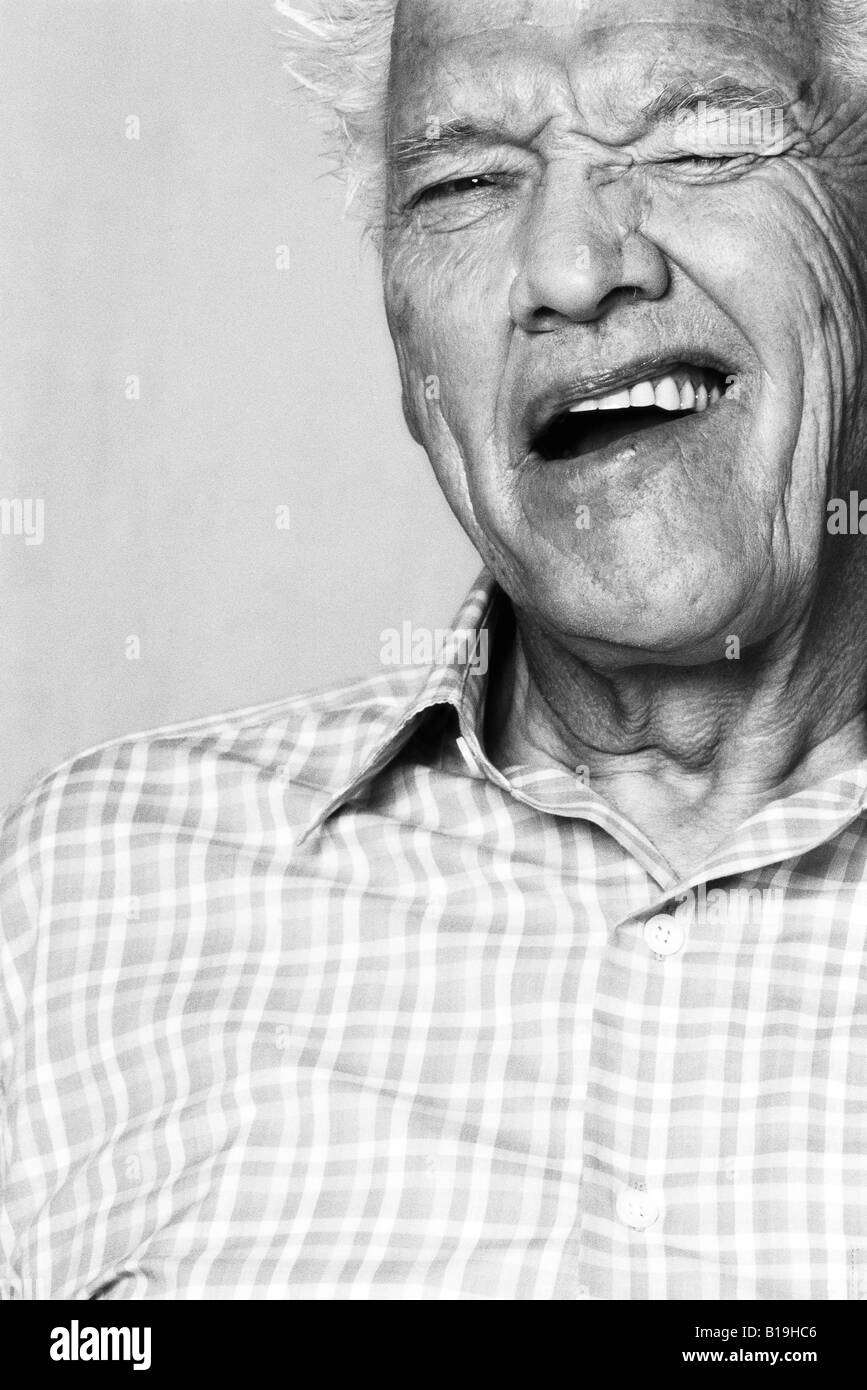 Senior man winking at camera, portrait, black and white Stock Photo