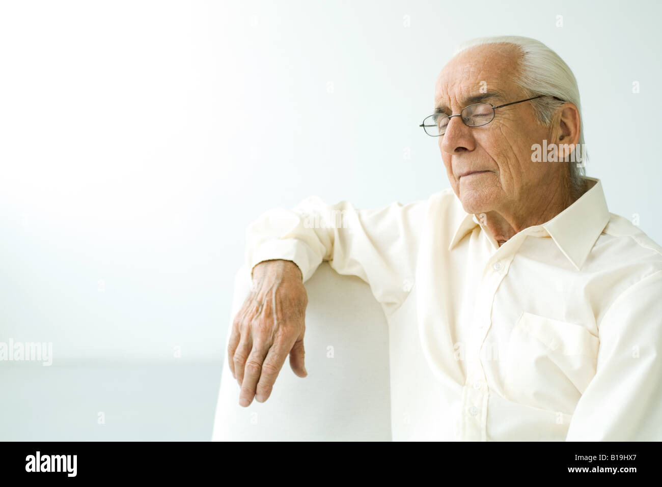 Senior man sitting on couch hi-res stock photography and images - Alamy