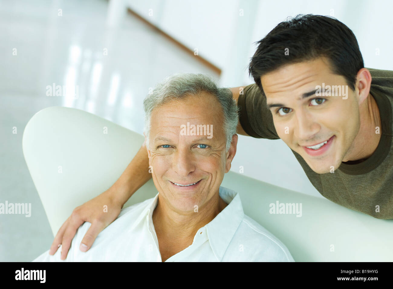 Father and adult son smiling at camera, portrait Stock Photo - Alamy