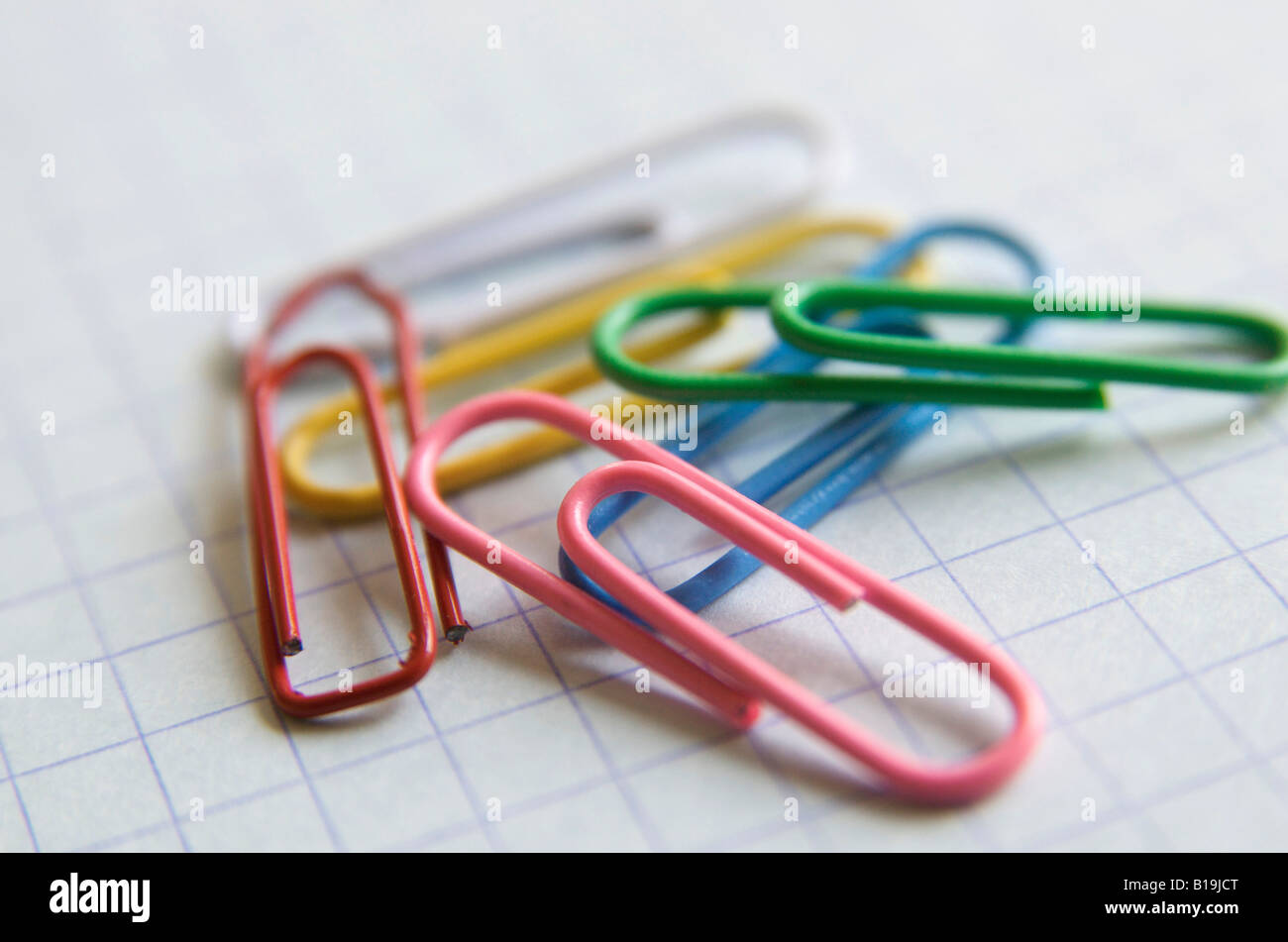 Paper clips on office paper background Stock Photo