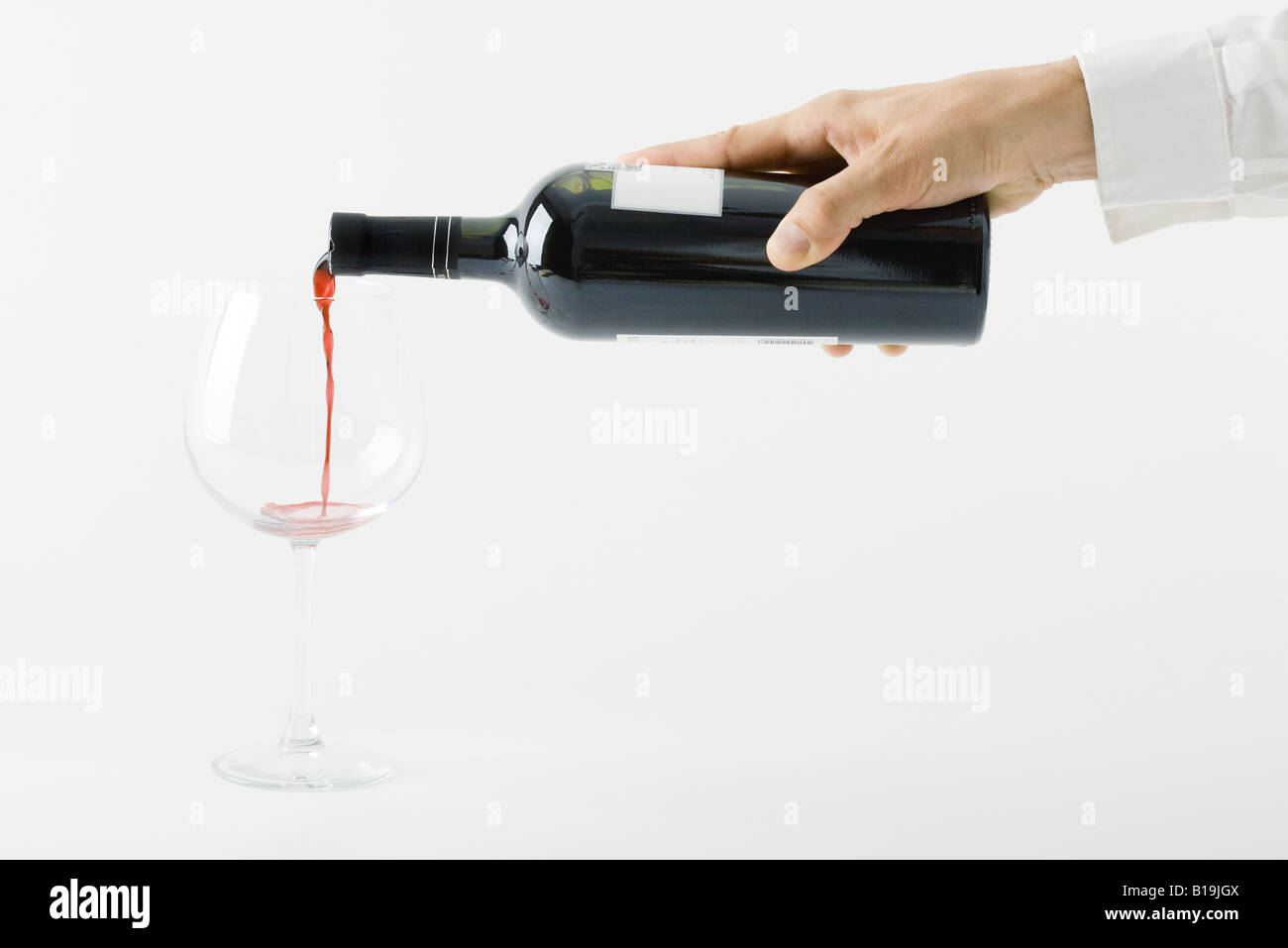 Man pouring red wine from bottle, cropped view of hand Stock Photo Alamy