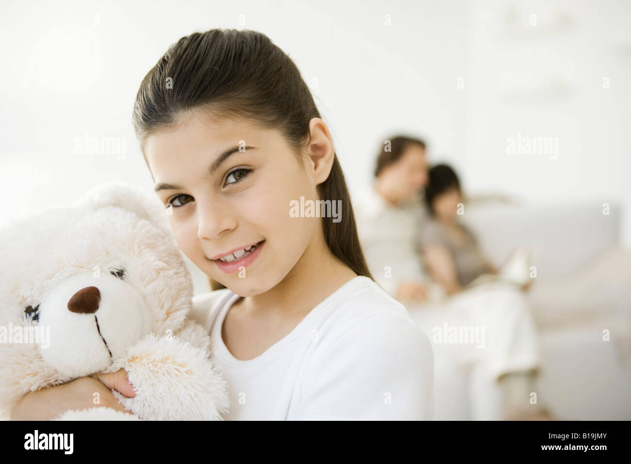 Little girl holding teddy bear, smiling at camera Stock Photo - Alamy