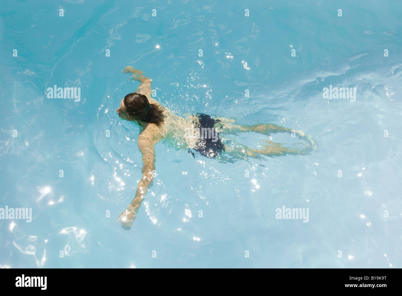 Man in swimming pool, arms out, high angle view Stock Photo Alamy
