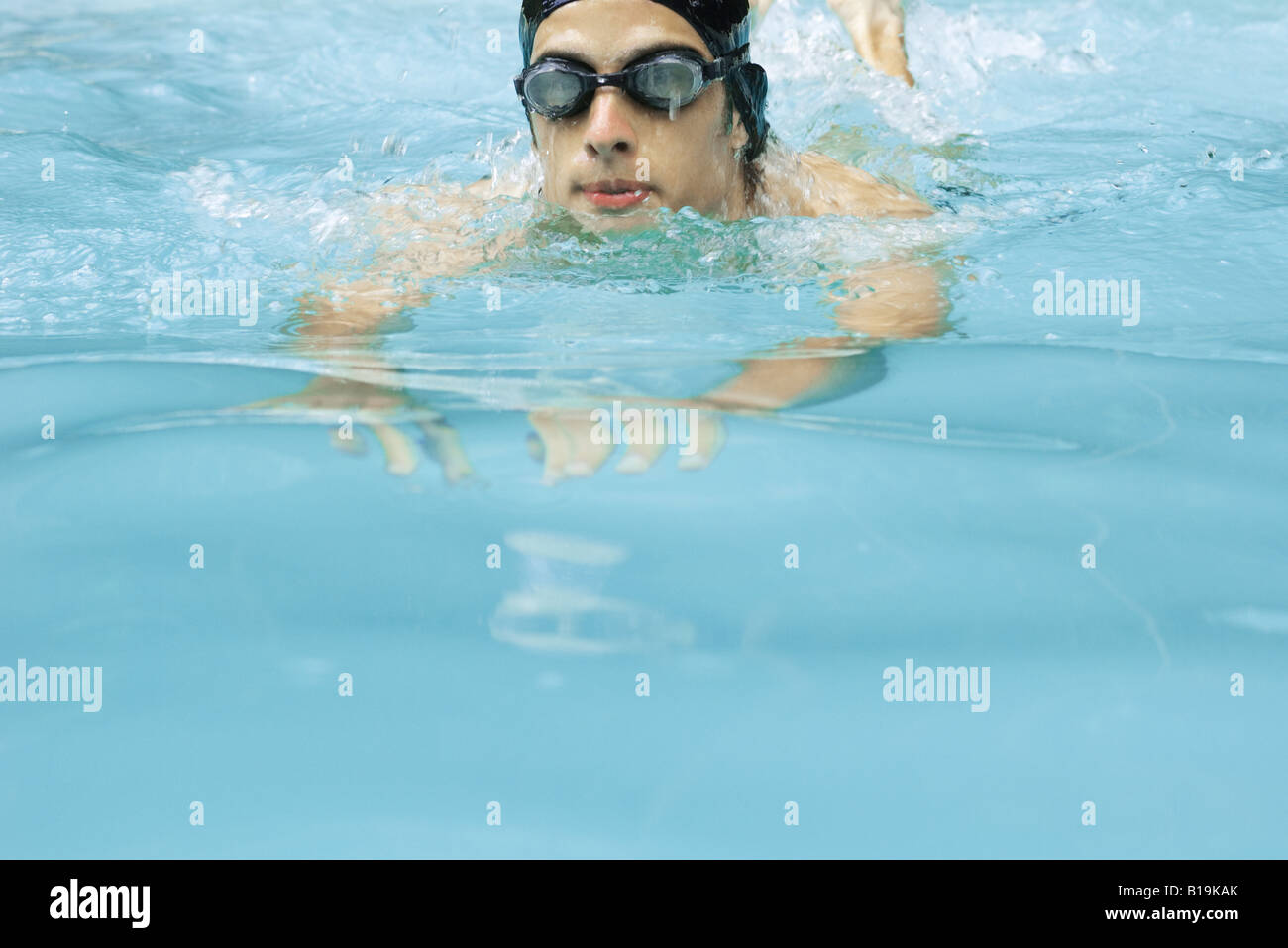Man swimming in pool, wearing goggles Stock Photo