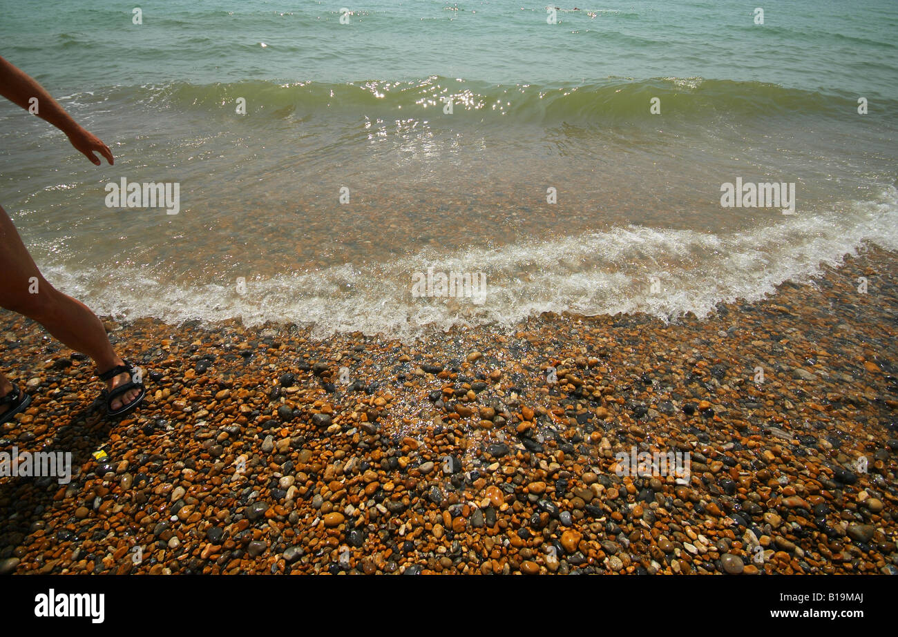 The sea washes ashore onto a stone beach Stock Photo