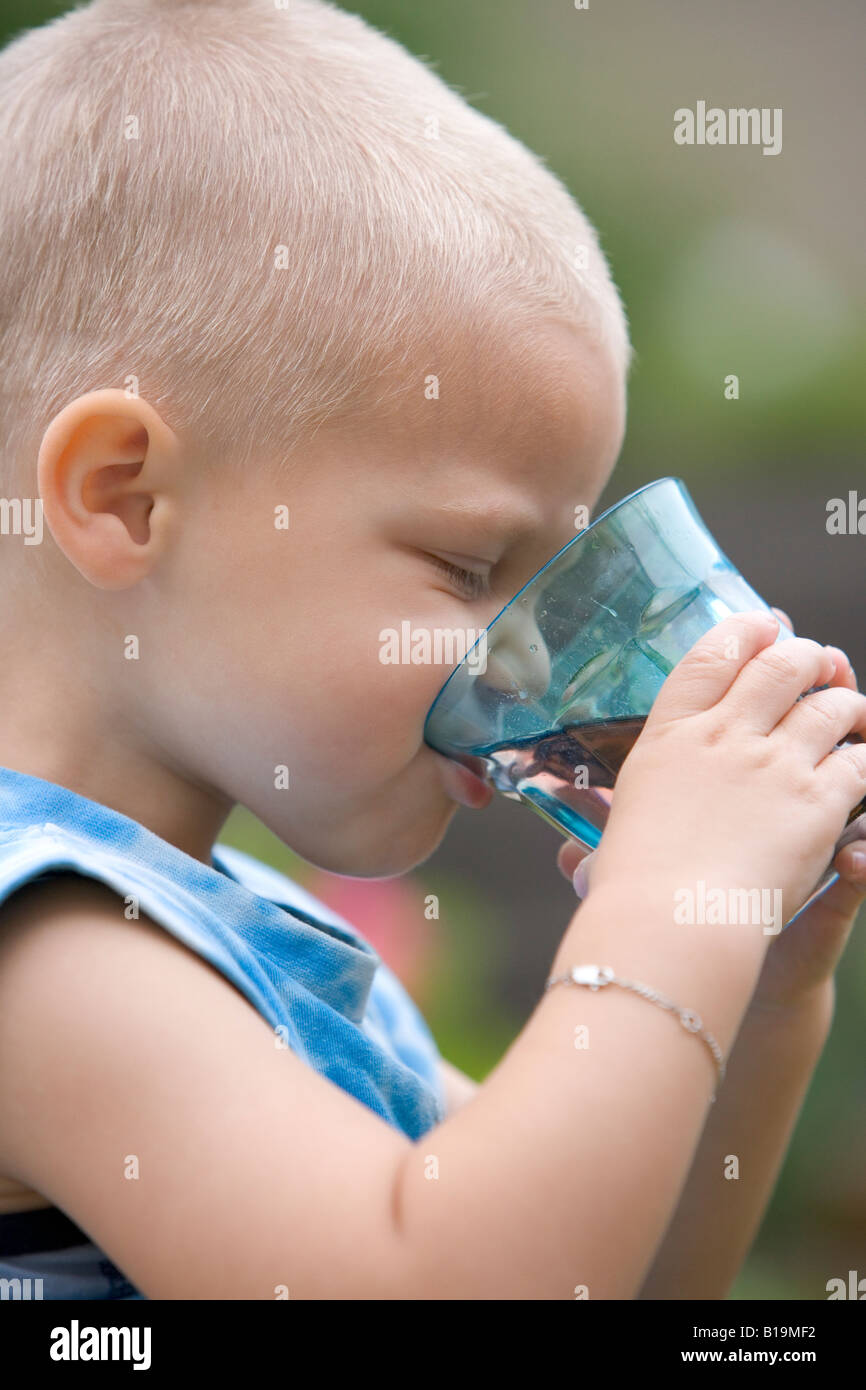 Blond toddler drinking lemonade Stock Photo