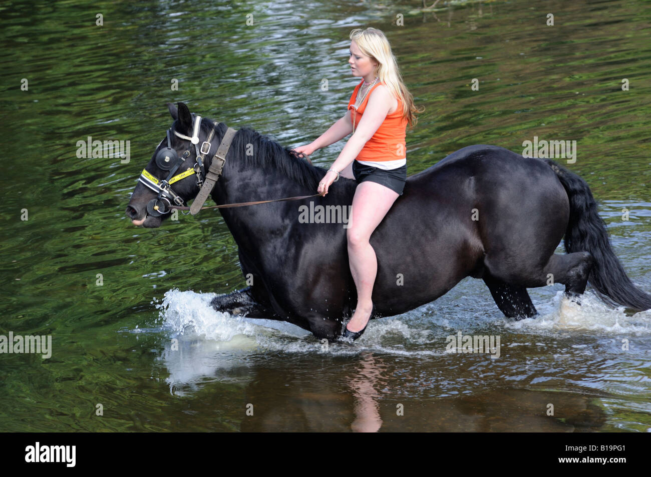 Gypsy traveller girl riding horse bareback in River Eden. Appleby Horse Fair. Appleby-in-Westmorland, Cumbria, England. Stock Photo
