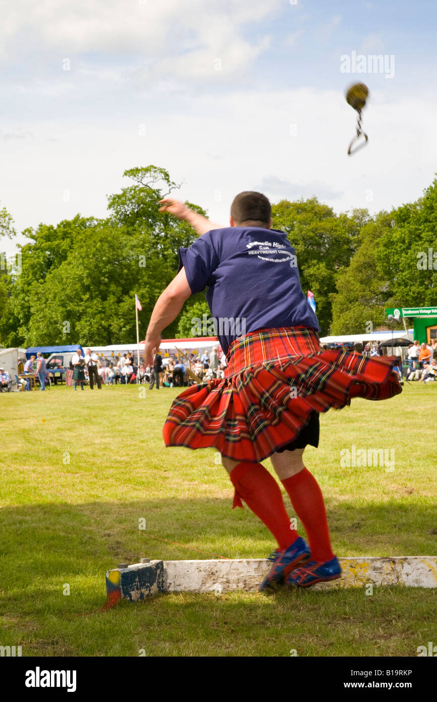 Scottish event, throwing a round metal ball chain stone shot, strongman  event at the Strathmore Highland Games Scotland UK Stock Photo - Alamy