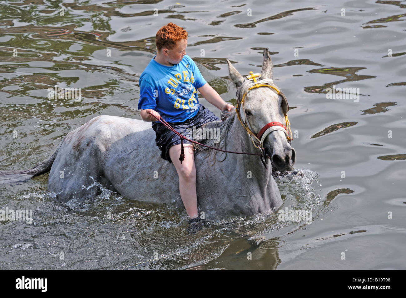 Gypsy traveller boy riding a horse in the River Eden. Appleby Horse Fair. Appleby-in-Westmorland, Cumbria, England. Stock Photo