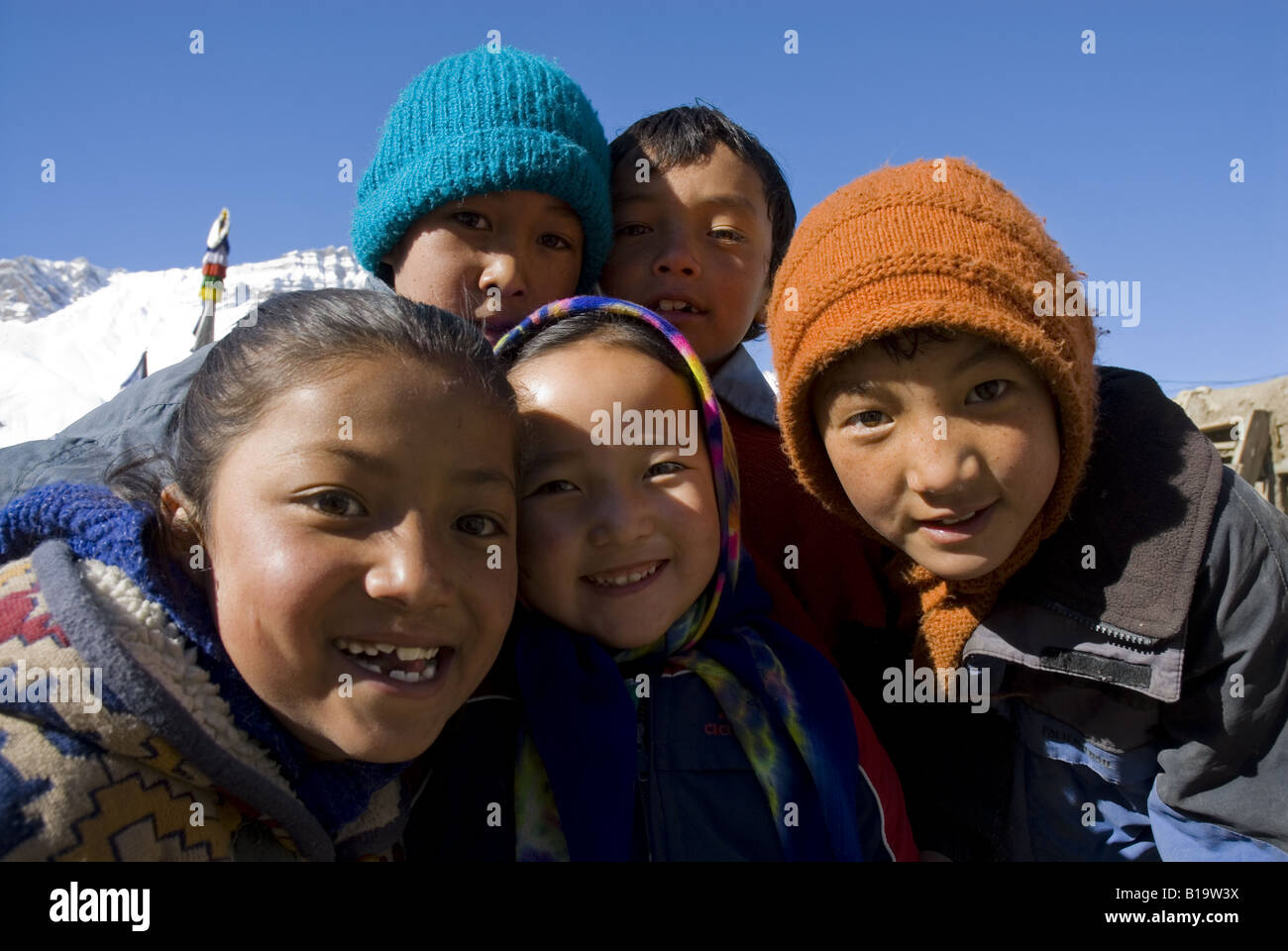 A group of happy children smiling into the camera in their school compound at Kaza. Spiti, Himachal Pradesh. India. Stock Photo