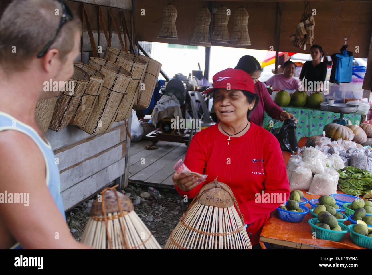 Buying basket work in a roadside market in Sarawak Stock Photo