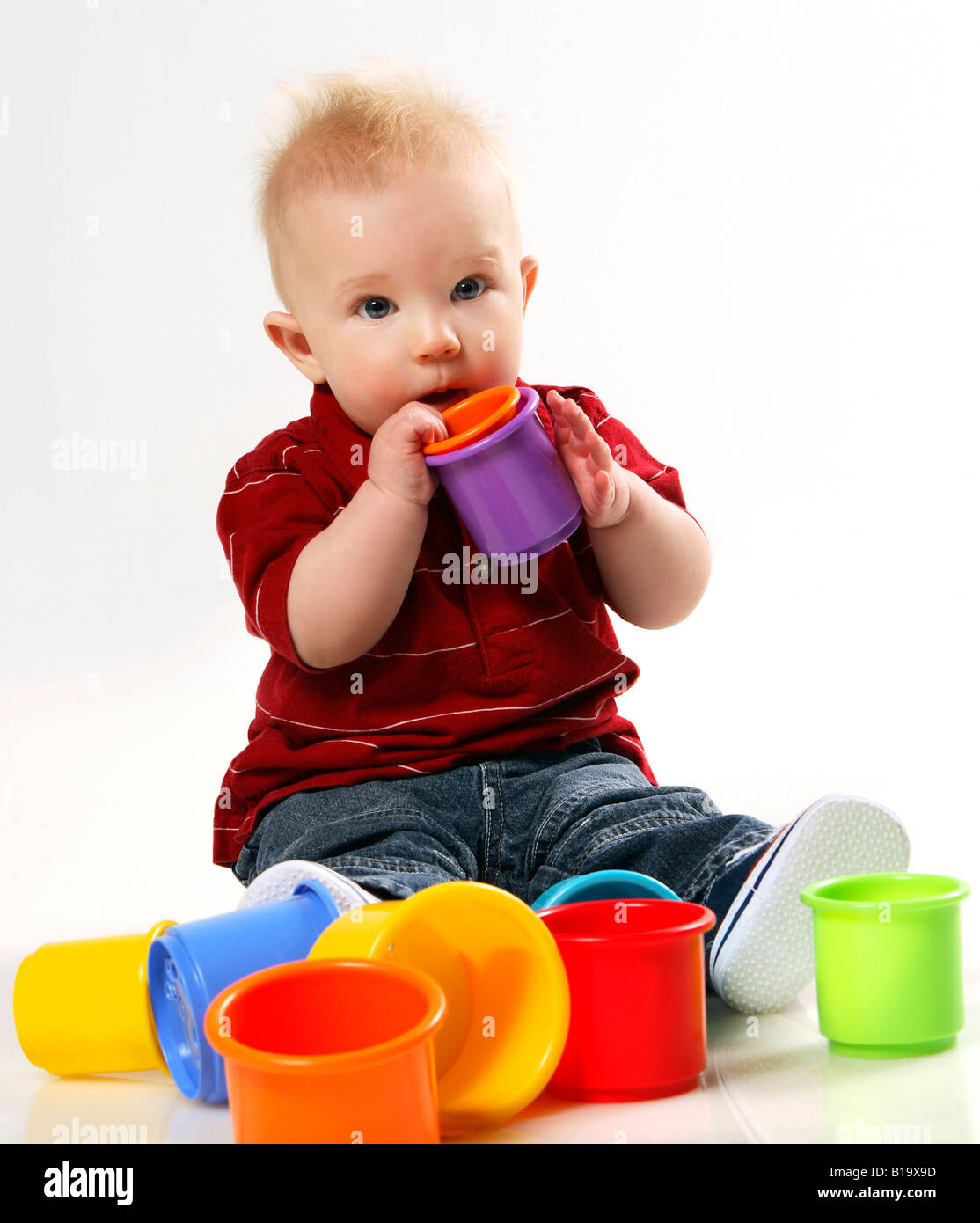 Baby boy playing with stacking cups Stock Photo Alamy