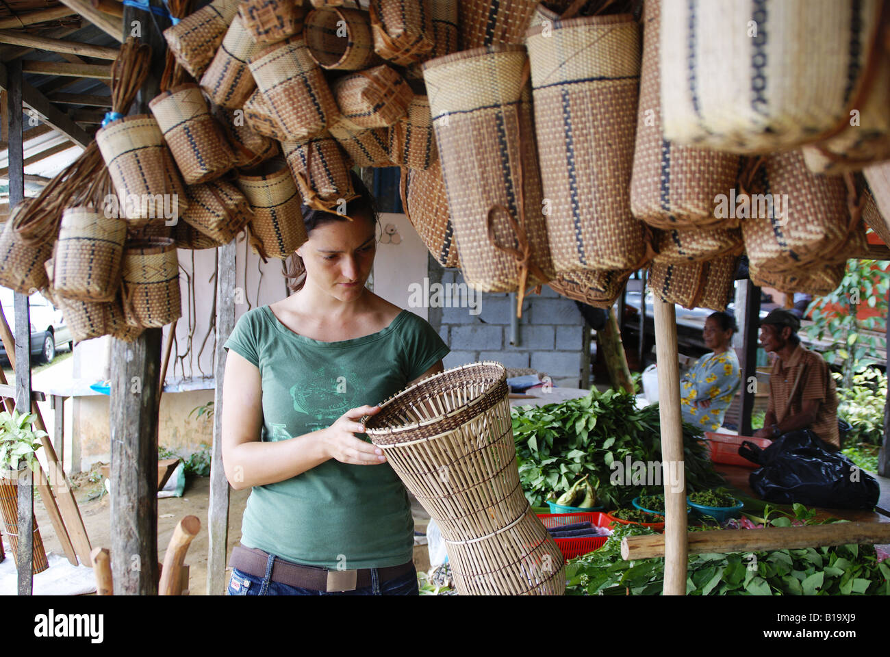 tourist buying basket work in a roadside market in Sarawak Stock Photo