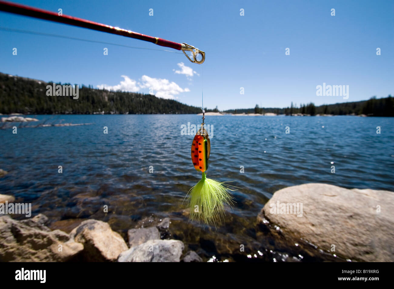 A fishing lure hangs from the end of a rod at Lake Alpine near Bear Valley, California on June 7, 2008. (Photo by Kevin Bartram) Stock Photo