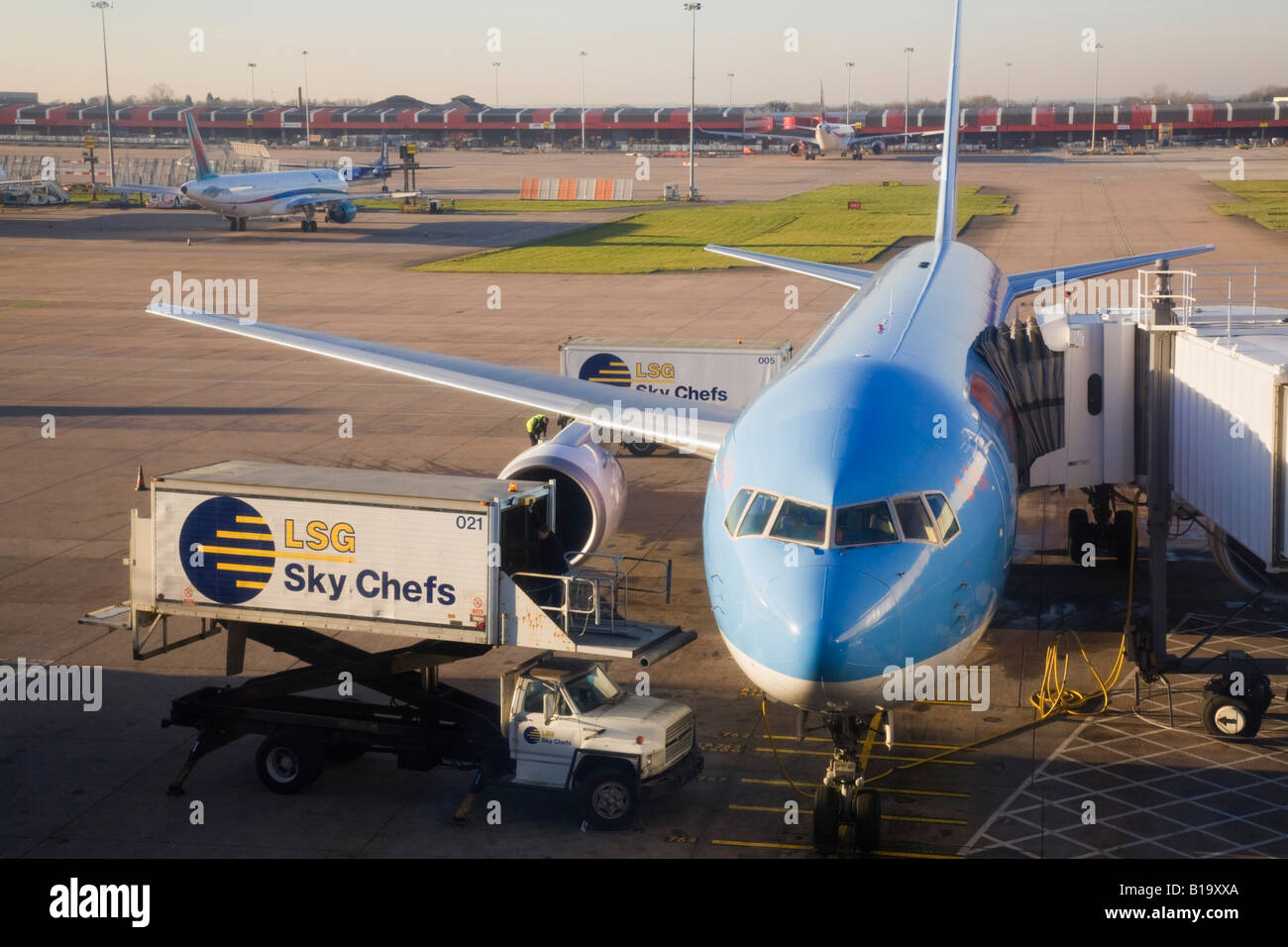 Manchester International Airport plane parked on tarmac at Terminal two with meals being delivered. Manchester England UK Stock Photo