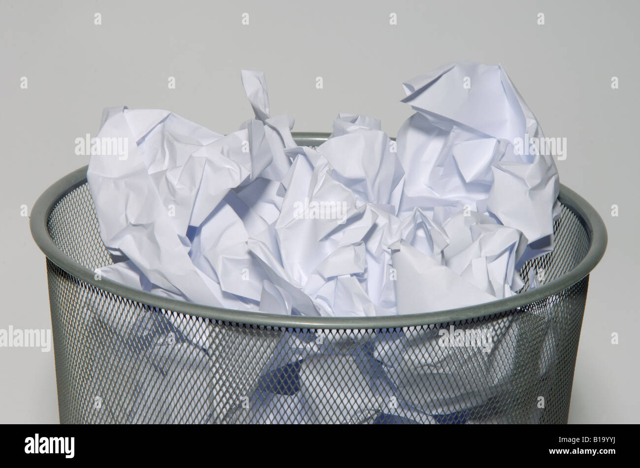 Waste paper bin full with crumpled document paper Stock Photo