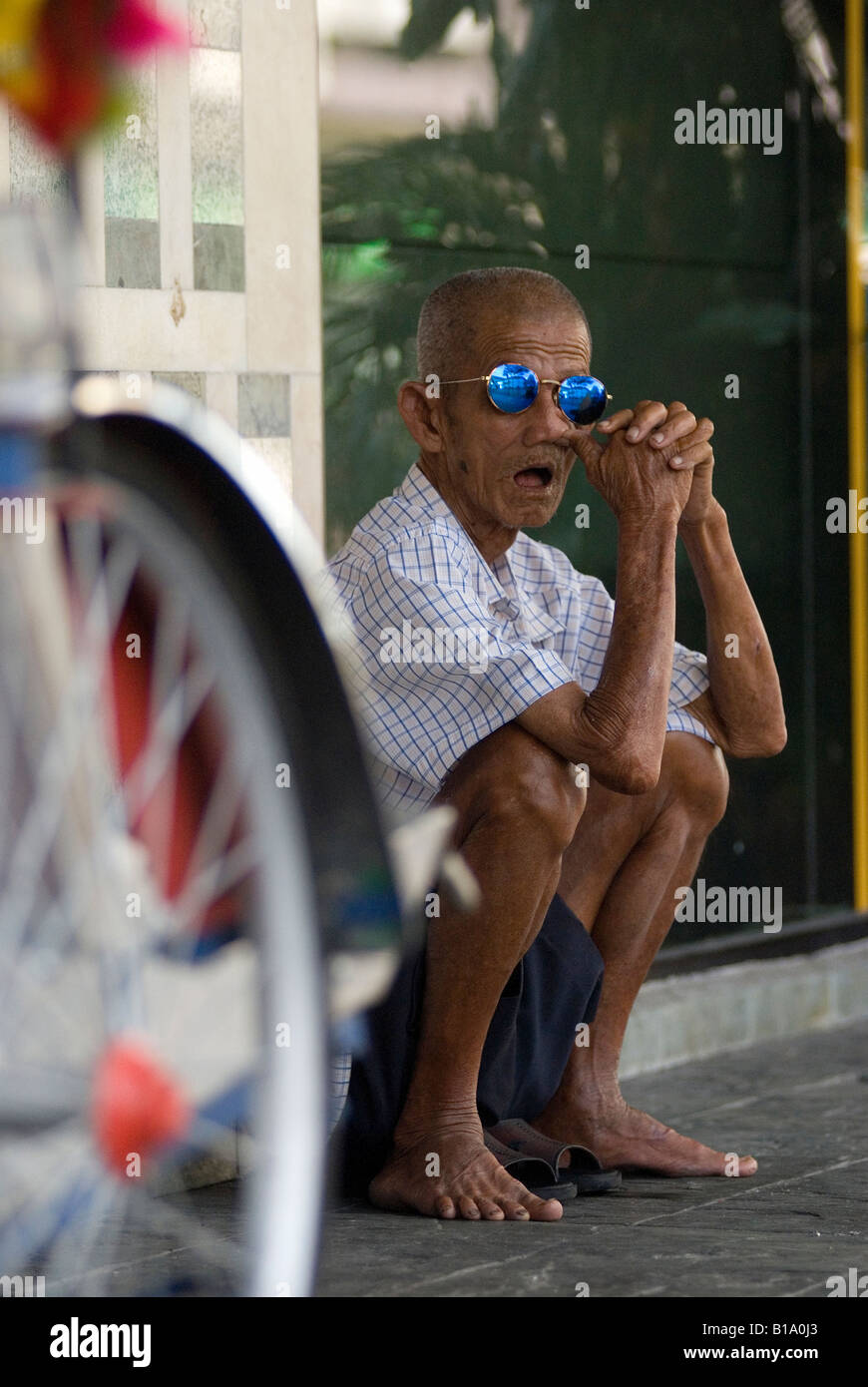 Elderly Trishaw Rider Takes A Break From The Malay Sun Stock Photo Alamy