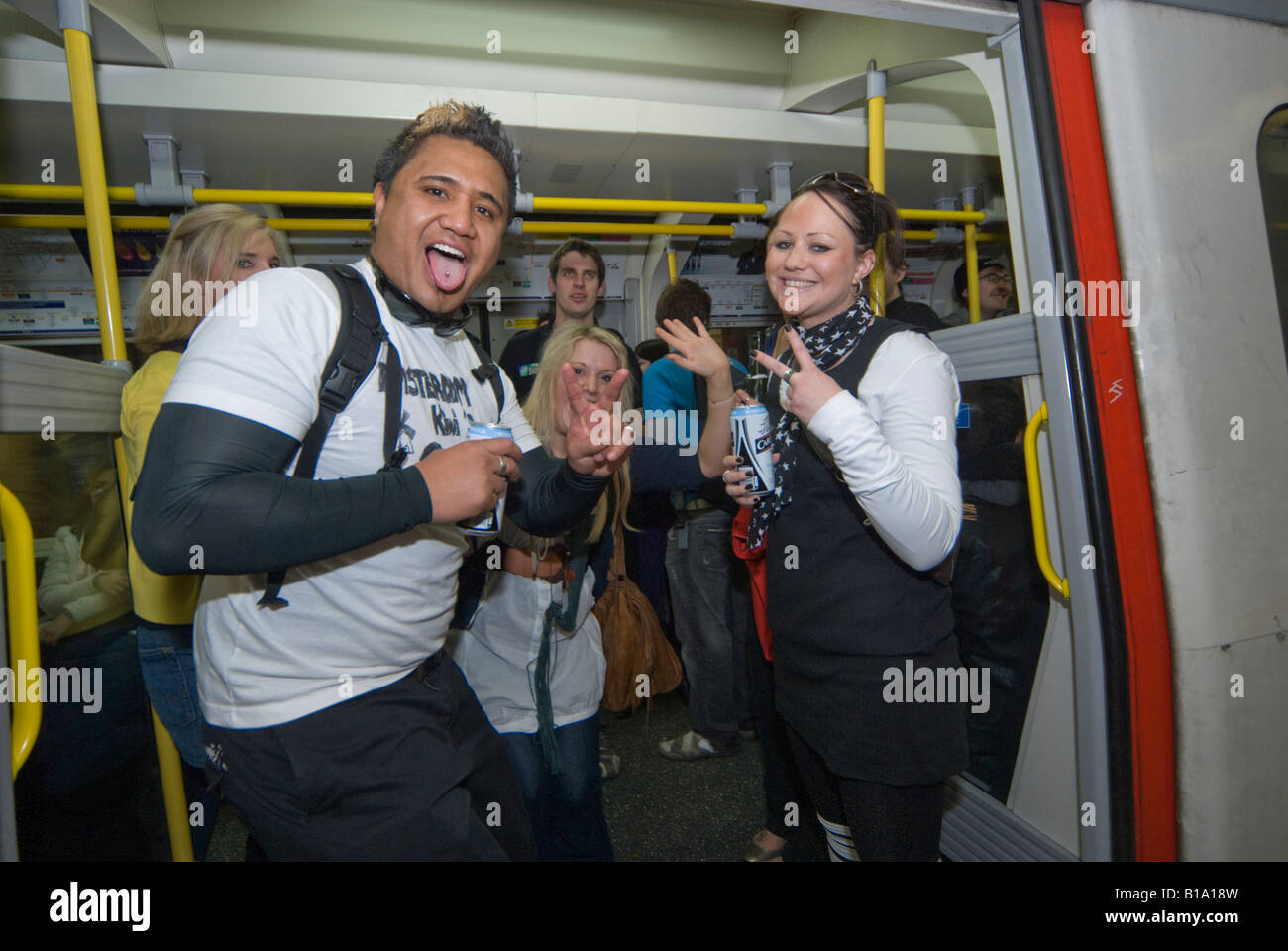 New Zealanders in an underground train doorway during the Waitangi Day Circle Line pub crawl, London Stock Photo