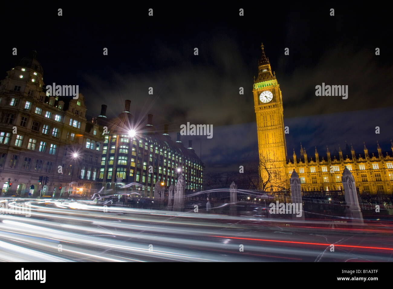 Traffic passes in front of Big Ben and Portcullis House in London, England. Stock Photo