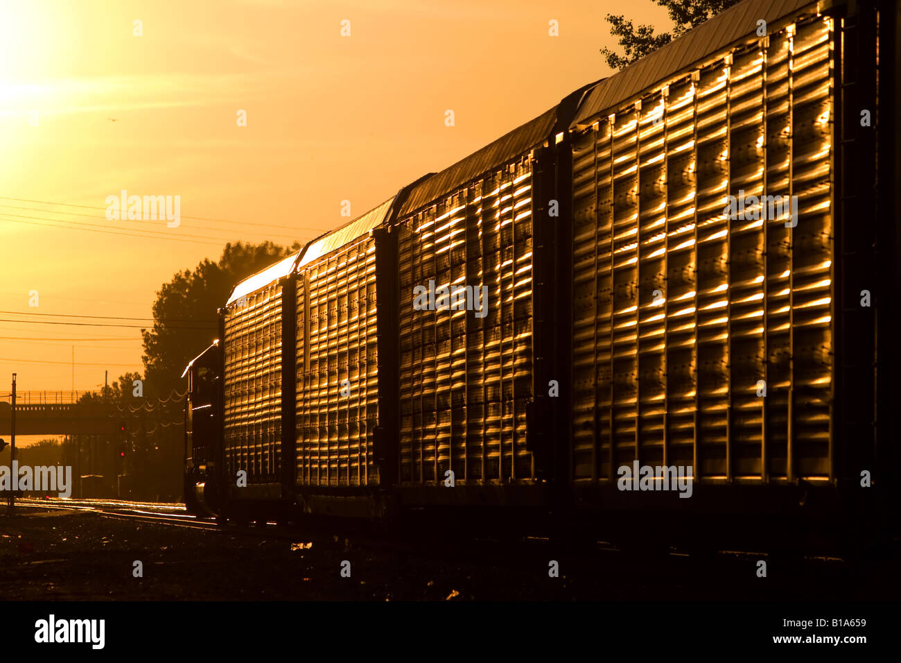 A westbound auto train heads into the setting sun. Stock Photo