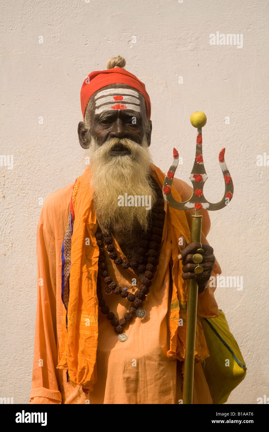 A wandering sadhu in Kerala, India. A Shiva devotee, the man carries a trident, a symbol of Shiva. Stock Photo