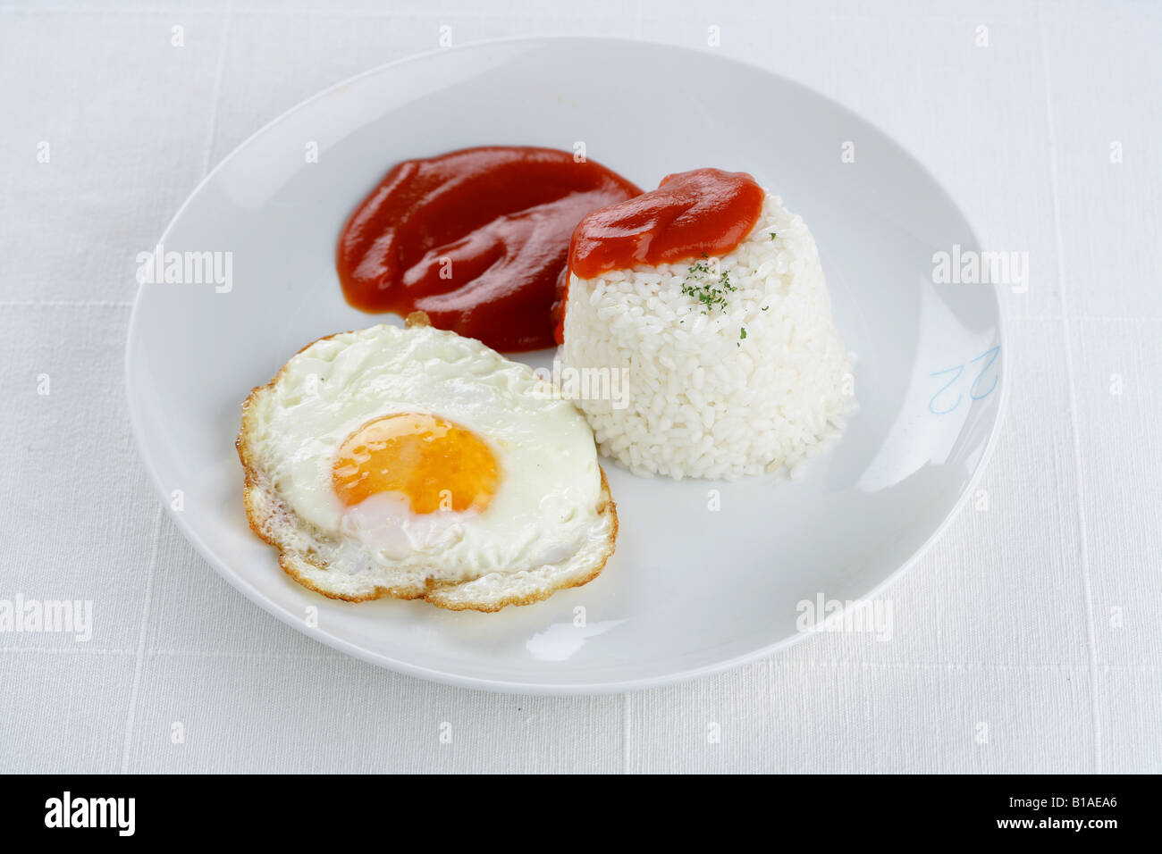 Rice with tomato and fried egg Stock Photo Alamy