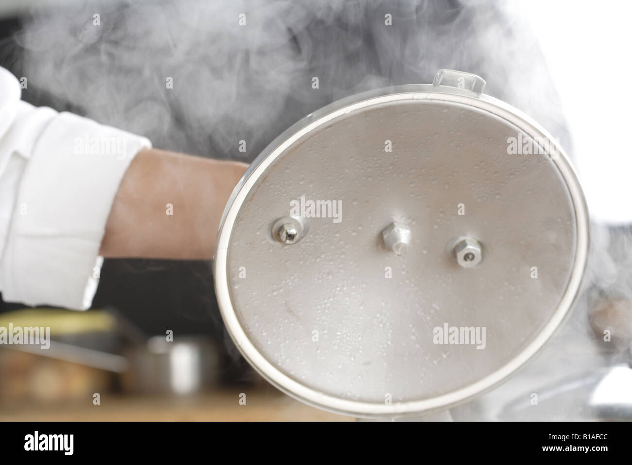 Removing the pressure cooker lid Stock Photo Alamy