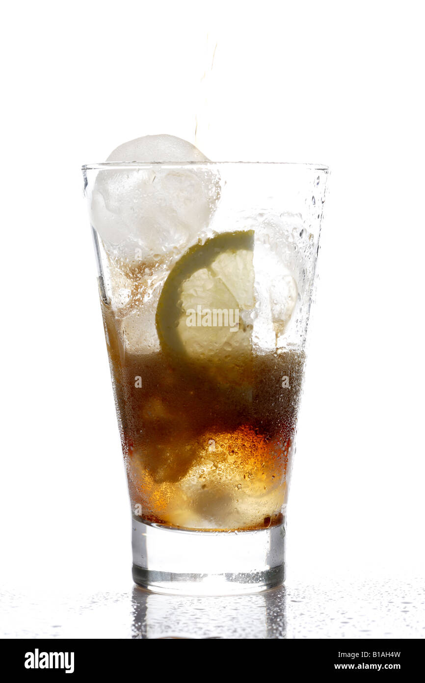 A glass of cola with ice cubes and a slice of lemon Stock Photo - Alamy