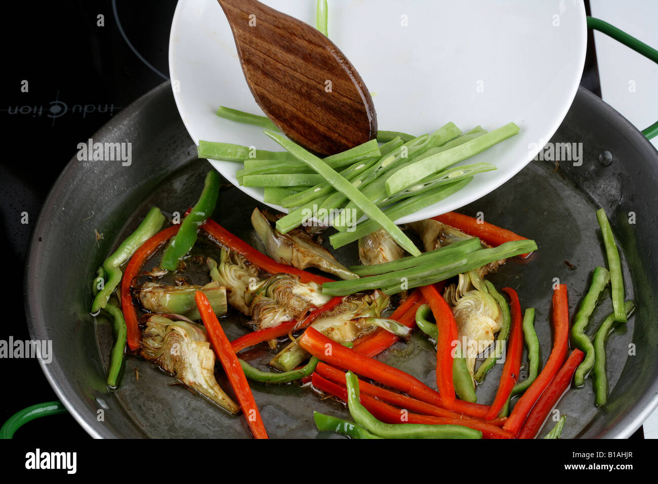 Frying green beans in paella pan Stock Photo Alamy