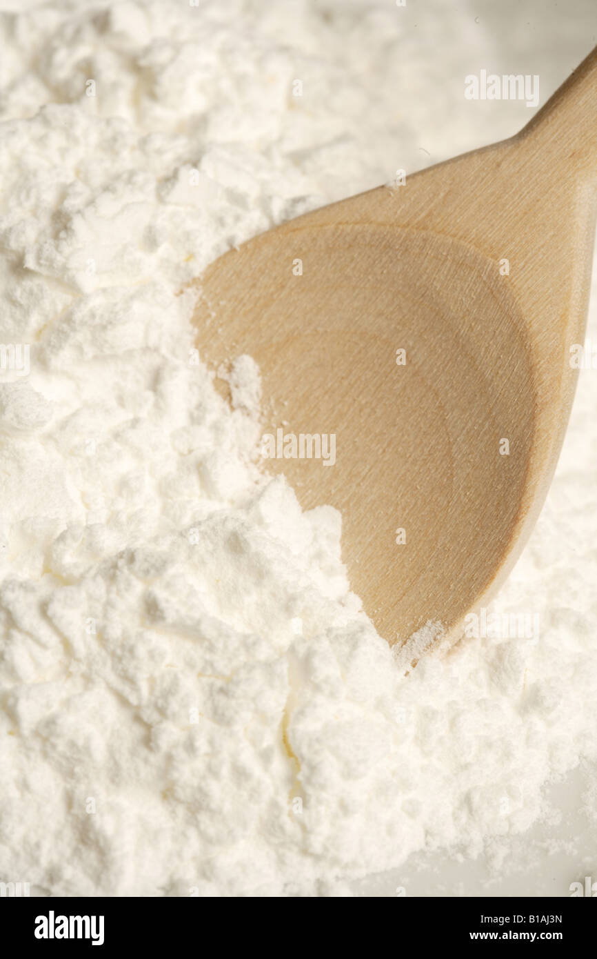 Wooden spoon in flour Stock Photo