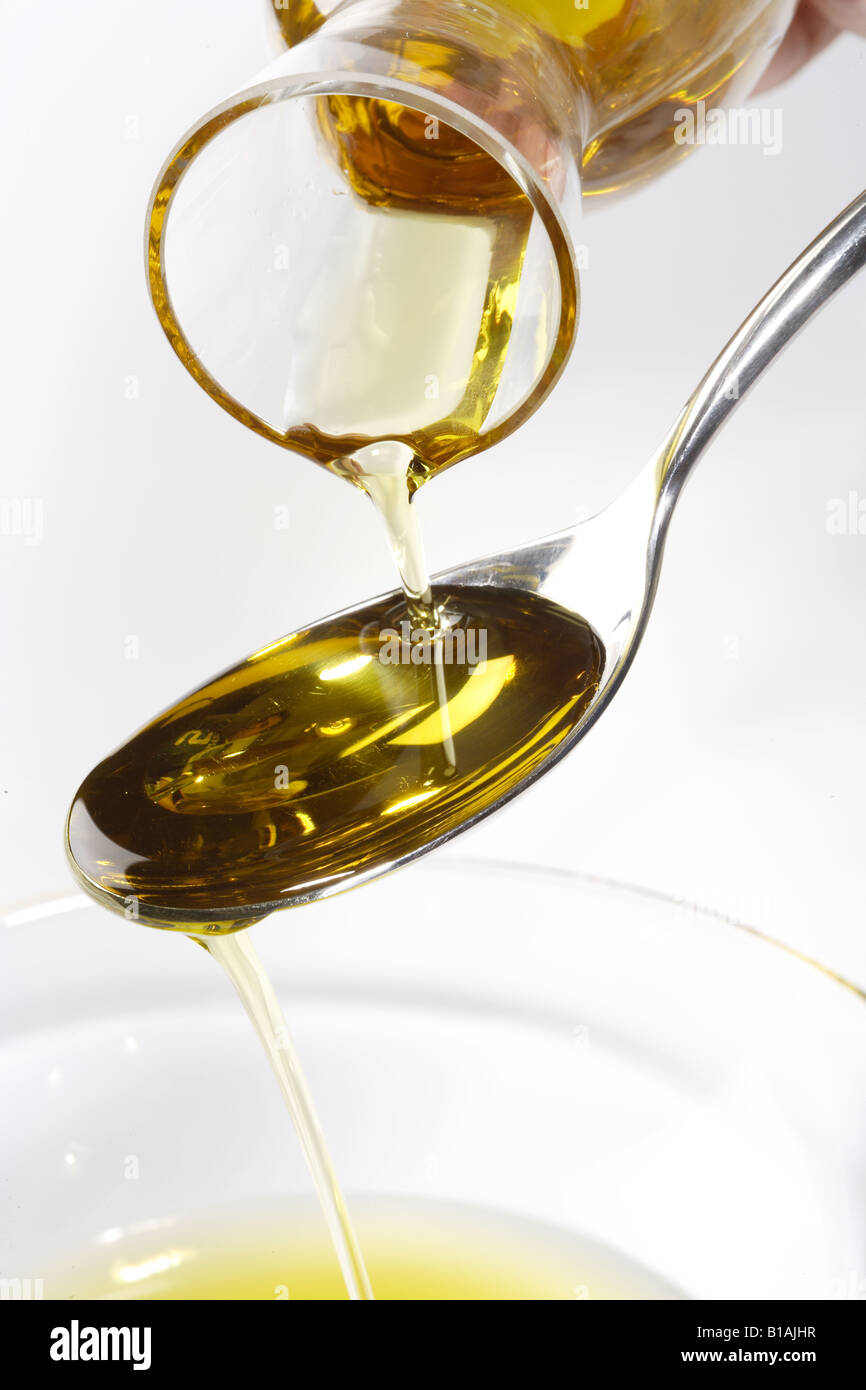 Pouring olive oil in a spoon Stock Photo - Alamy