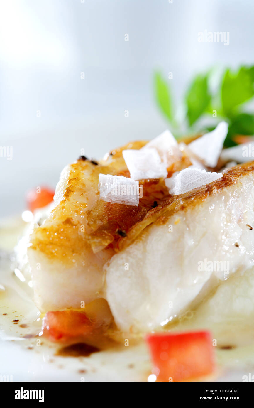 Scorpion fish loins with cauliflower cream, tomatoe and truffles Stock Photo