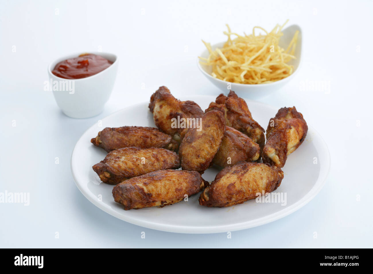 Chicken wings with BBQ sauce and chips Stock Photo